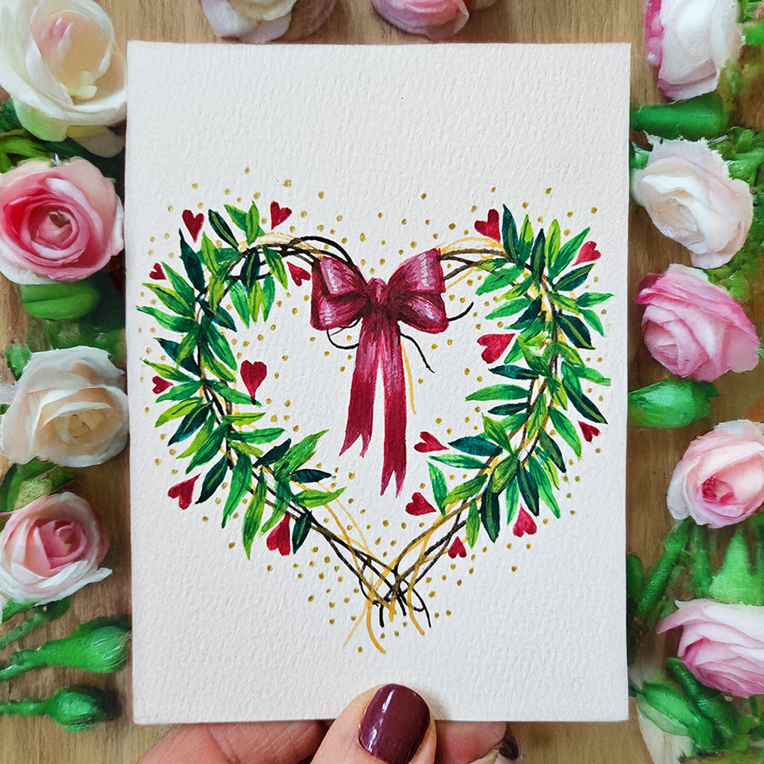 A painted heart garland on textured white paper: a depiction of the design you can create if you follow the Castle Arts 'Make your own Valentine's card' tutorial.